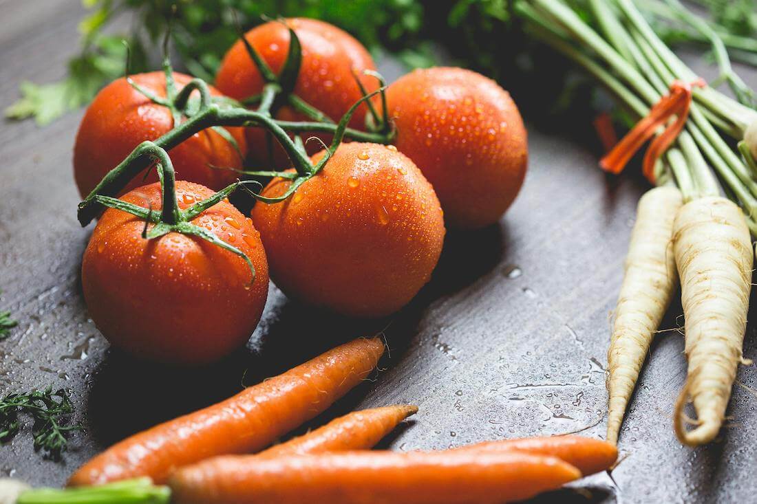 An assortment of vegetables that are easy to grow in the UK, including tomatoes